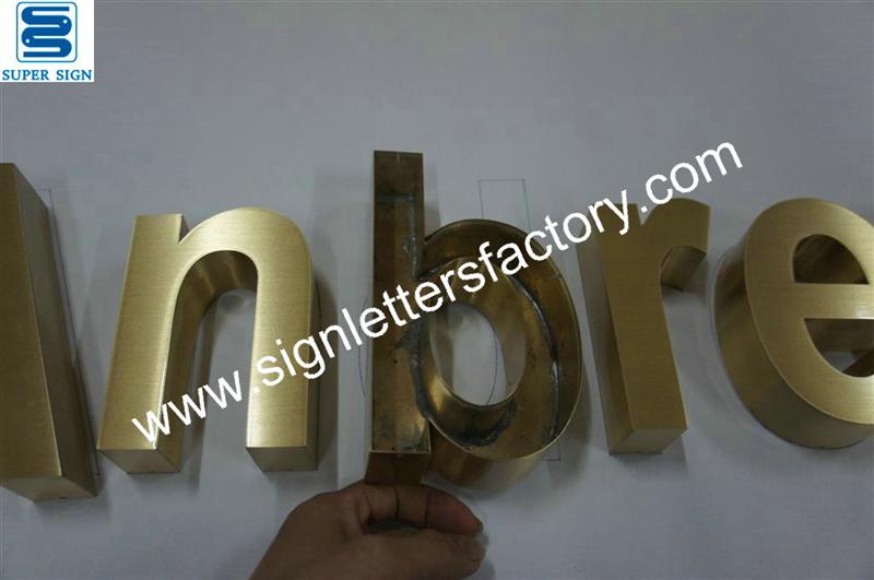 fabricated brushed brass sign lettering